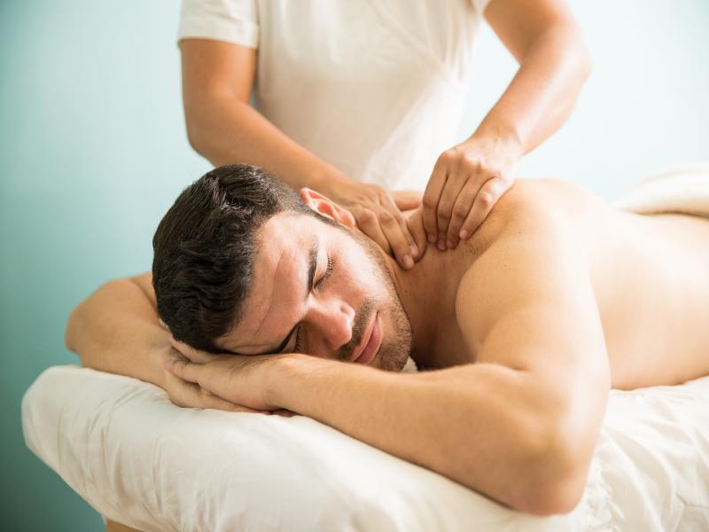 very-relaxed-young-latin-man-getting-deep-tissue-massage-his-back-wellness-spa-clinic